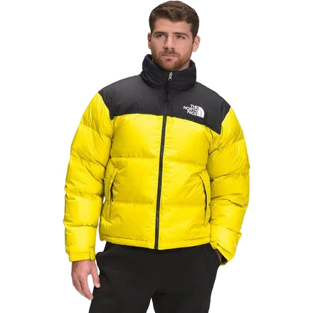 Man wearing a yellow and black The North Face jacket on a white background