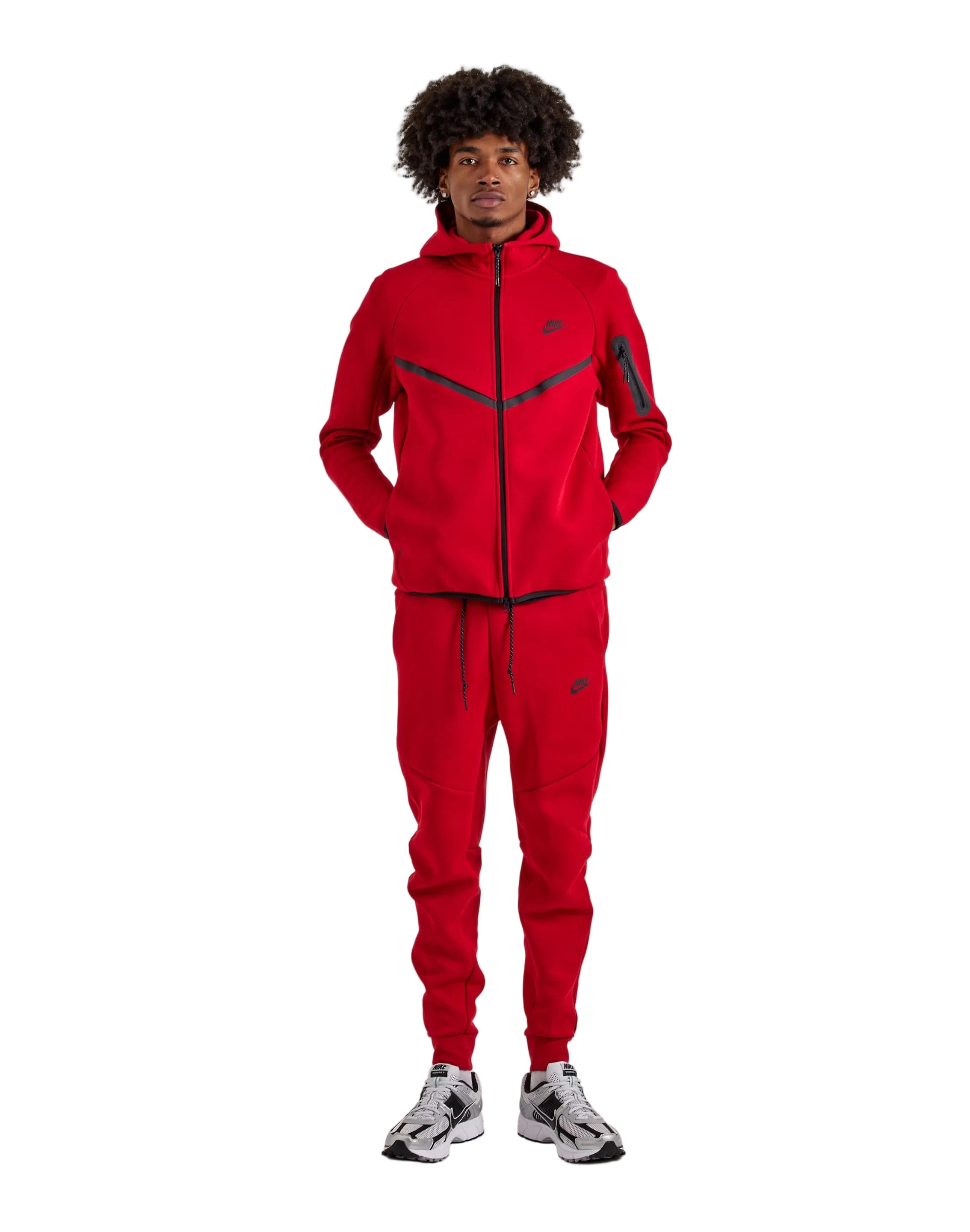 Person wearing a red tracksuit with a brand logo on a white background
